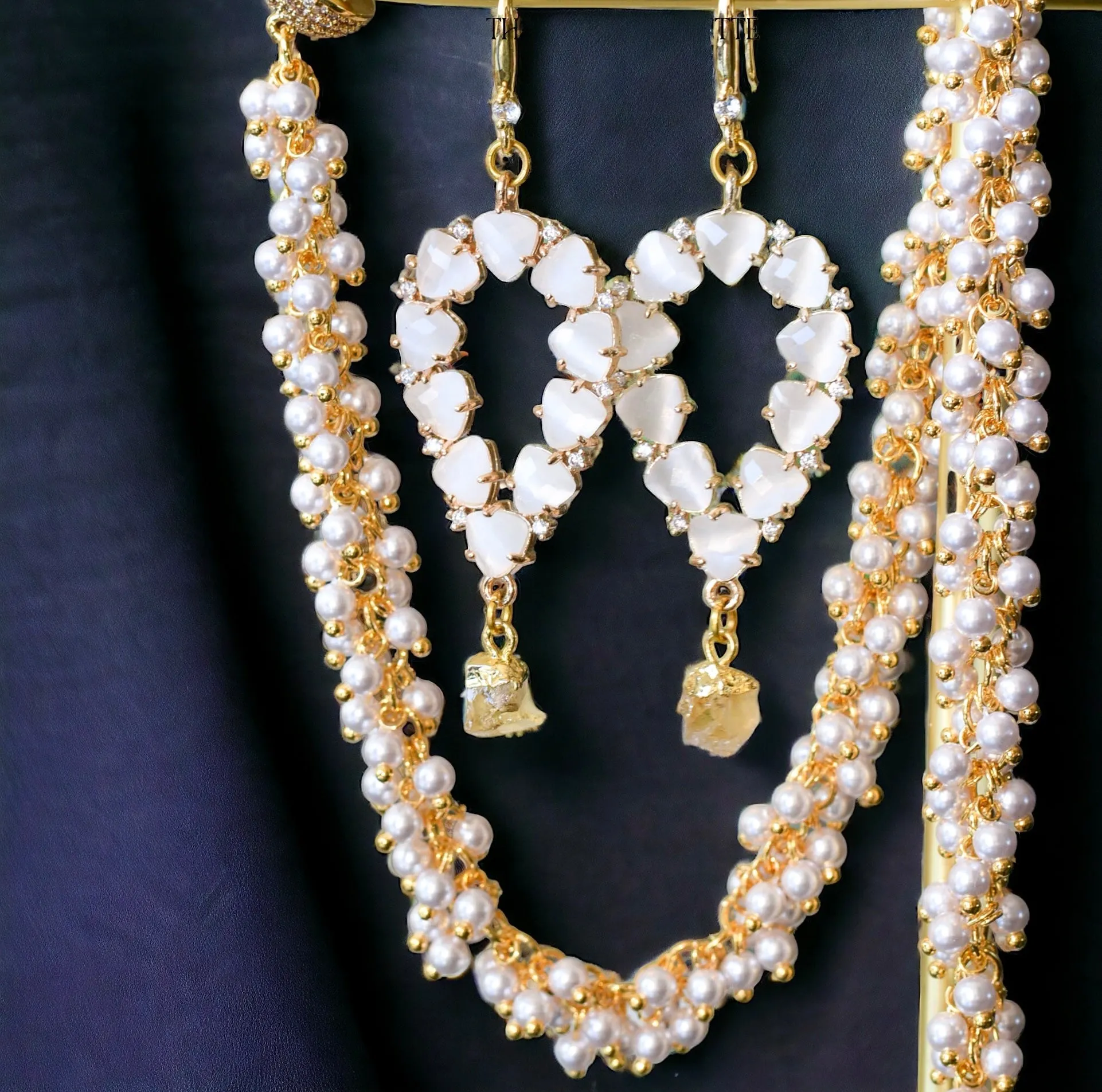Yara white stones with gold edged emerald drop earrings